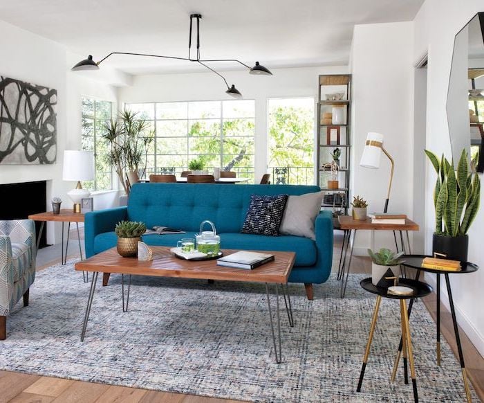 white-walls-mid-century-modern-living-room-blue-sofa-with-wooden-coffee-table-and-side-tables-blue-and-white-carpet-on-wooden-floor